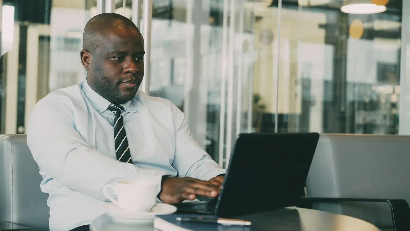 A professional working at a laptop